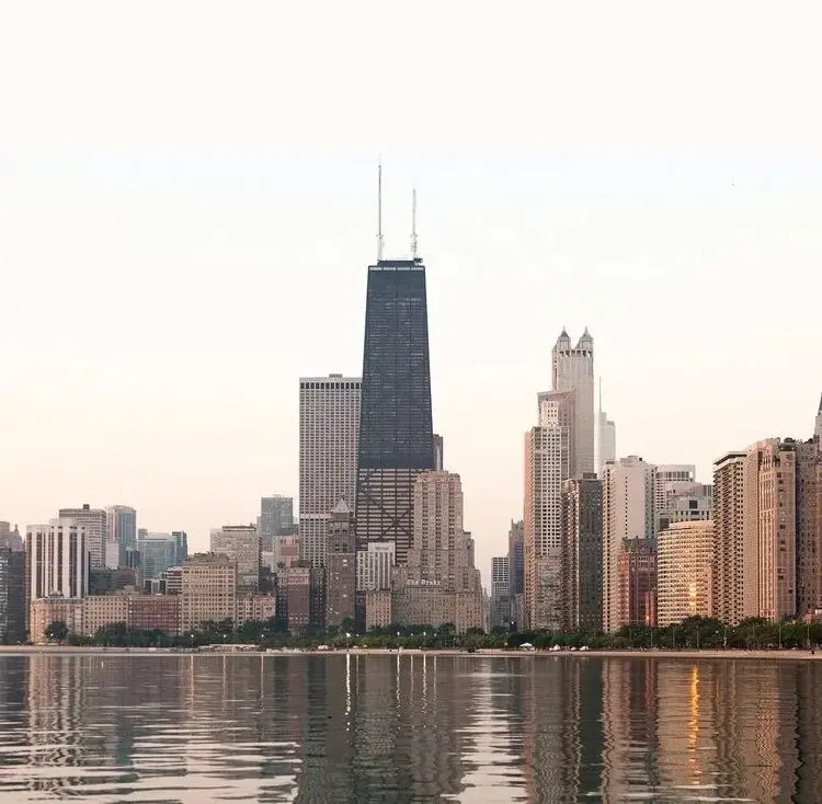 A view of the chicago skyline from across the water.
